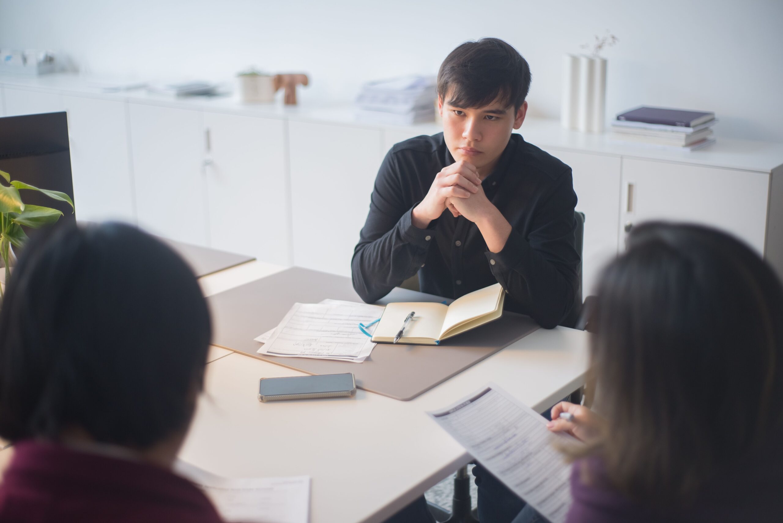 Focused business team in discussion during a meeting in a contemporary office environment.